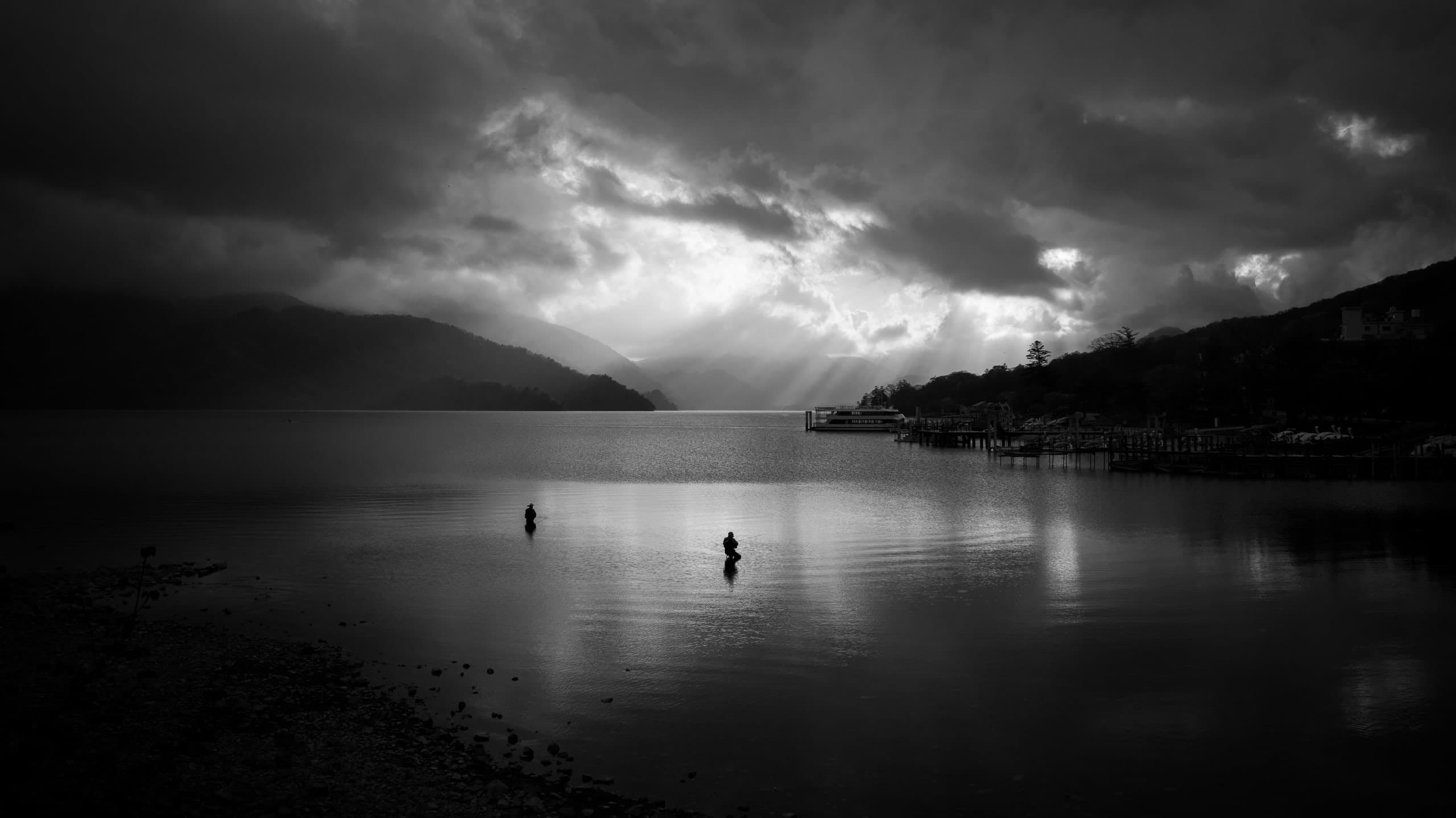 Large lake with 2 fishermen on shallow water