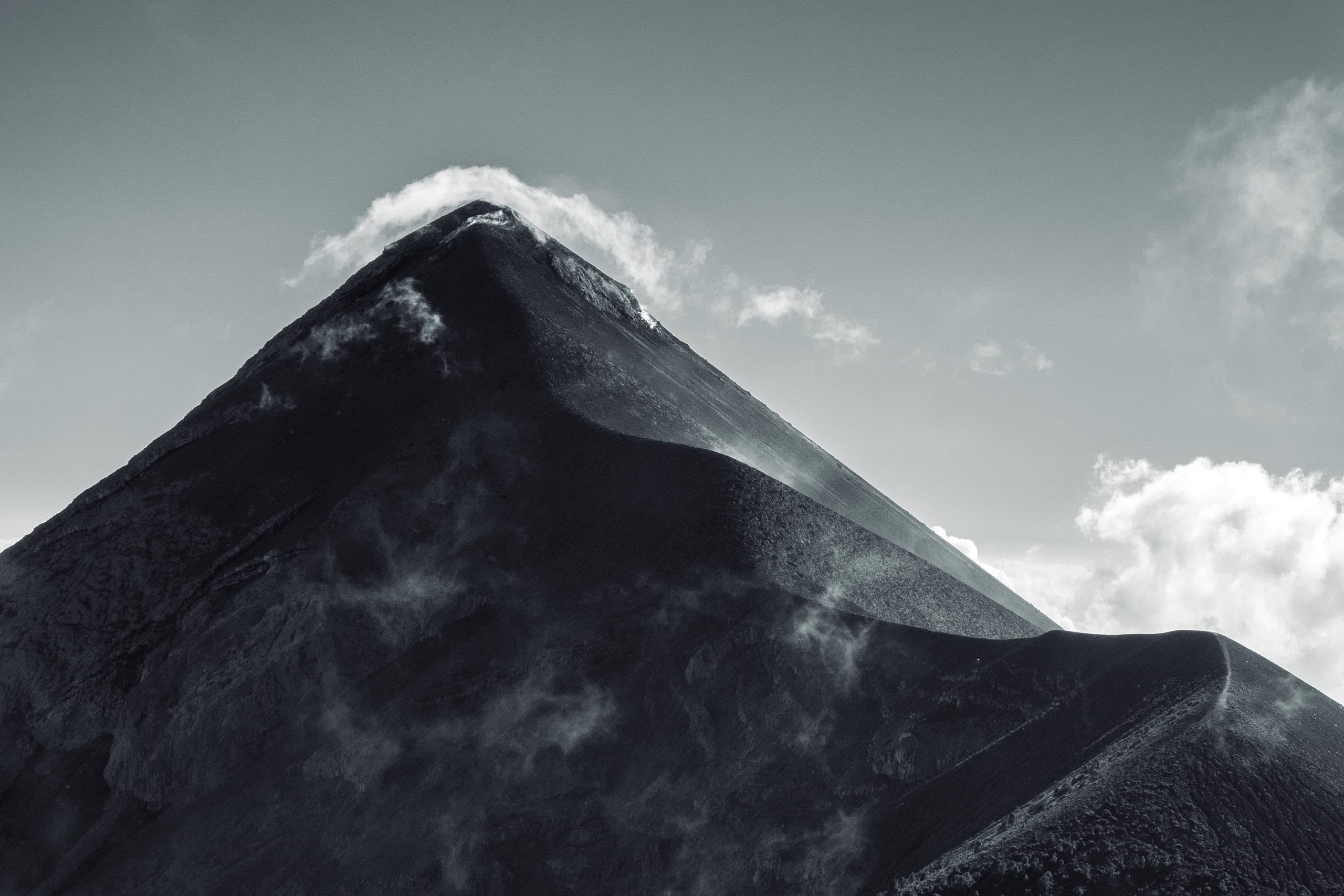 Triangular shaped active volcano with a windy path leading to it