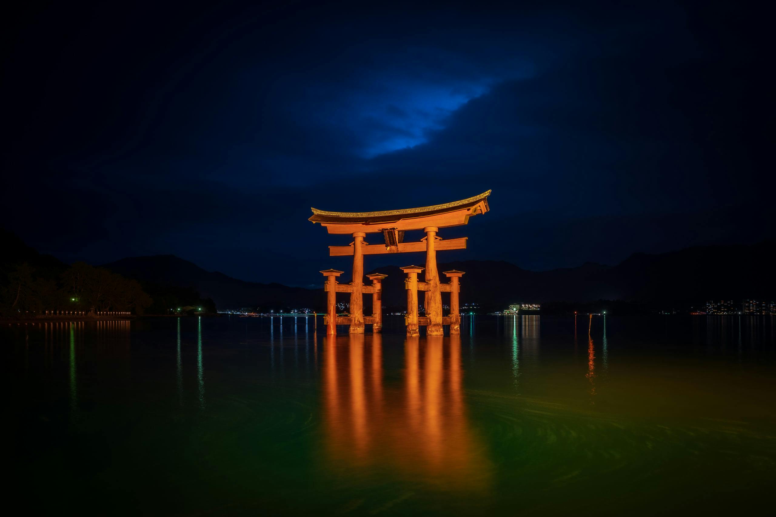 Floating torii gate on water at night